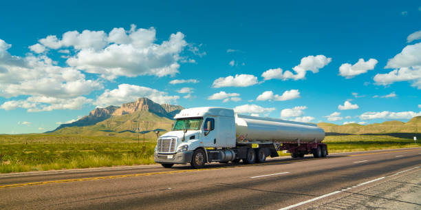 Fuel tanker truck on a rural highway in Texas with El Capitan mountain in the back